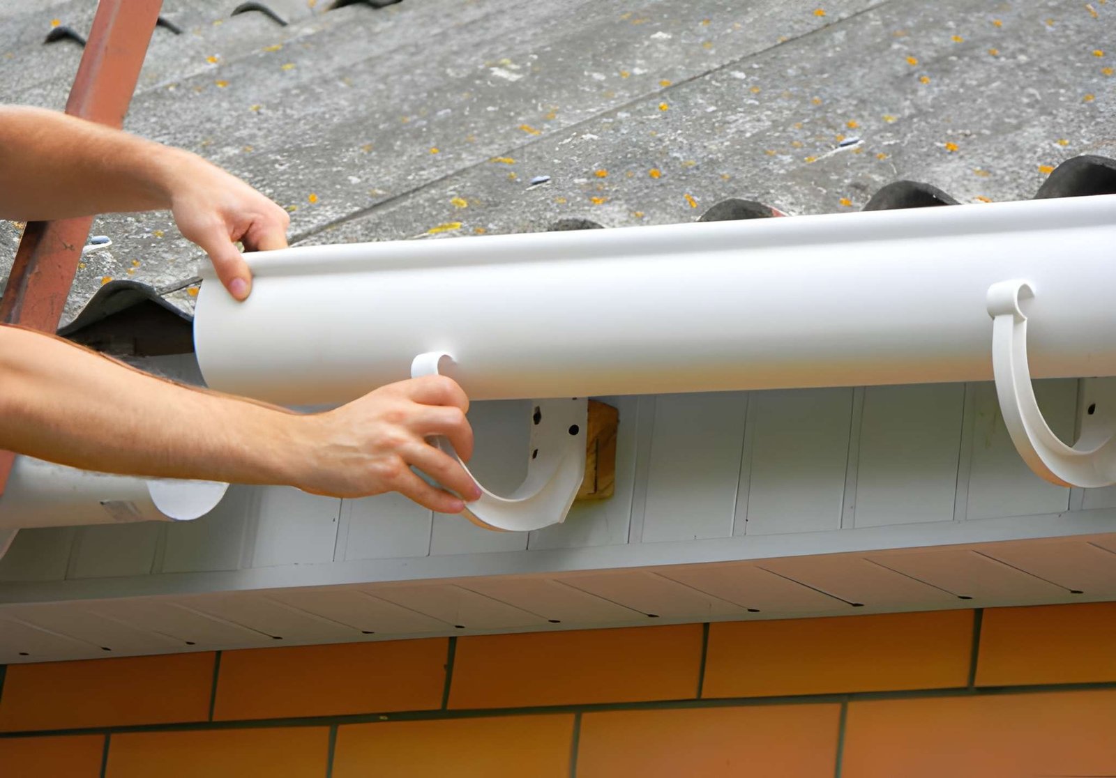 Professional gutter installation on residential roof